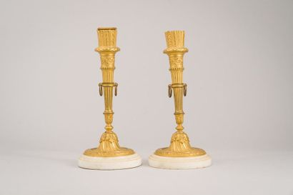 null Pair of gilt bronze torches in the shape of a quiver resting on a circular base...