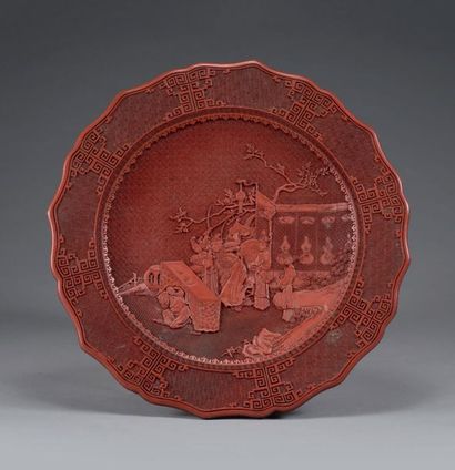 CHINE Important dish in red lacquer with an incised decoration of an animated scene...