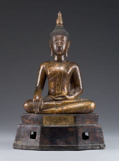 null Partially gilded
bronze Buddha statue depicted sitting in padmasana on a stepped...