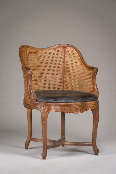 null Caned office armchair with wrap-around backrest in finely moulded beechwood...