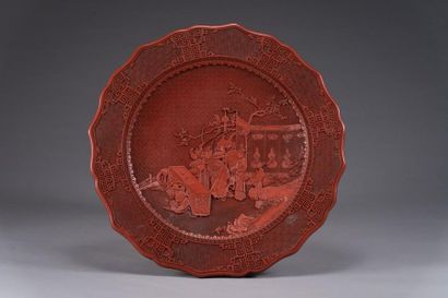 null CHINA:
Large dish in red
lacquer with incised decoration of an animated scene...