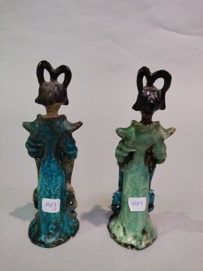 null CHINA:

Two blue-green enamelled earthenware pendant statuettes representing...