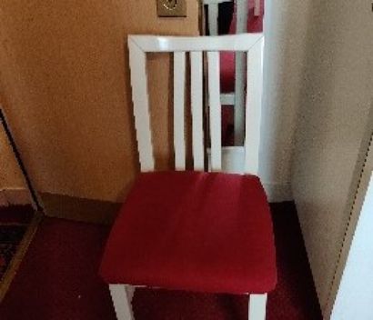 Two cream lacquered chairs, red seat in coated...