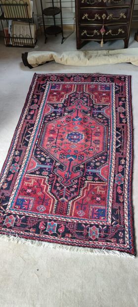 null Oriental carpet with a central red medallion on a blue background. 

Two other...