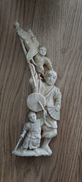 null Carved ivory okimono.

Japan, circa 1940.

Decorated with a man holding a "Fish"...