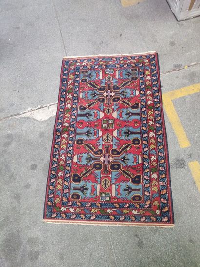 null Oriental carpet with a central red medallion on a blue background. 

Two other...