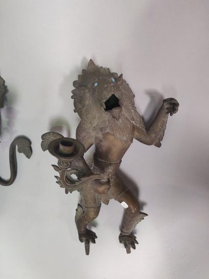null Pair of bronze torches in the shape of a lion holding a branch. Missing the...