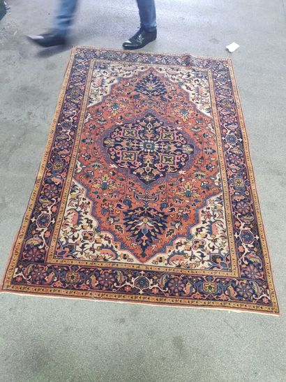null Oriental carpet with a central blue medallion on a red background.

173 x 113...