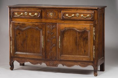 null 193. A moulded and carved oak sideboard

decorated with stylized flowers. It...