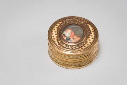 null A round box decorated with orange enamel dots on a cream background, the lid...