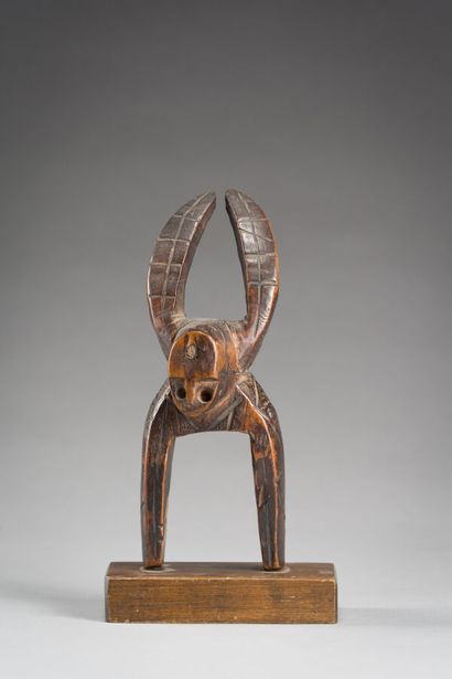 27. Pulley stirrup of loom with head of deity...