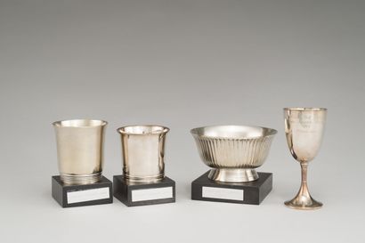 null A set of silver-plated golf cups, two of which are conical, one flared with...