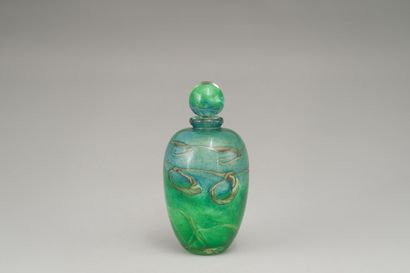 null Covered bottle in blown glass with free blue and green nuanced decoration.

Dated...