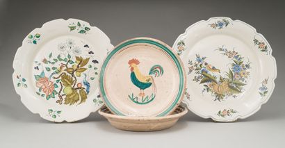 null Two important earthenware dishes, model with contoured edge decorated with birds...