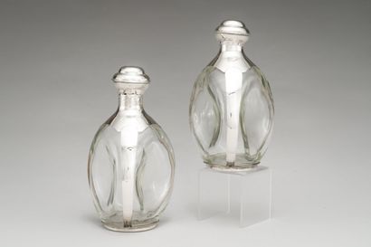 null Two carafes and their stopper out of moulded glass, the setting out of silver...
