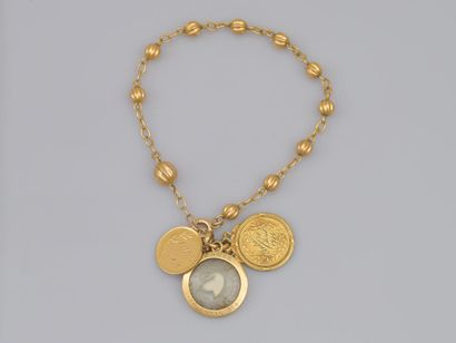 null 46. Lot de deux bijoux en or 18K (750) comprenant : un
bracelet scandé de boules...