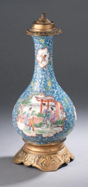 CHINE (Canton) Vase bouteille en porcelaine à décor polychrome et or dans des réserves...