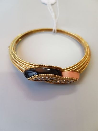 null Bracelet jonc articulé en or jaune (750/1 000e) à motifs de perles, le centre...