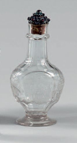 null Small baluster-shaped bottle with molded glass panels engraved with scrolls...