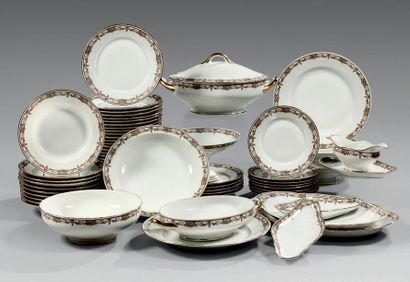 null A white Limoges porcelain set with a golden rim and a wing decorated with floral...