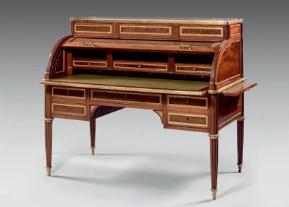 null Mahogany cylinder desk with brass mouldings opening at the top with three drawers,...