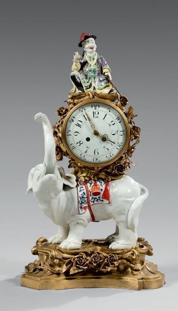 null Large clock decorated with a porcelain elephant carrying the movement decorated...