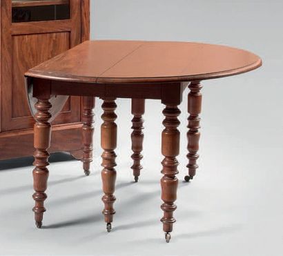 null Walnut dining room table with two flaps. Six turned legs with wheels.
(One-foot...