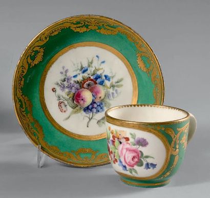 SÈVRES A cup and saucer, polychrome decoration of fruit and flower bouquets in reserves...