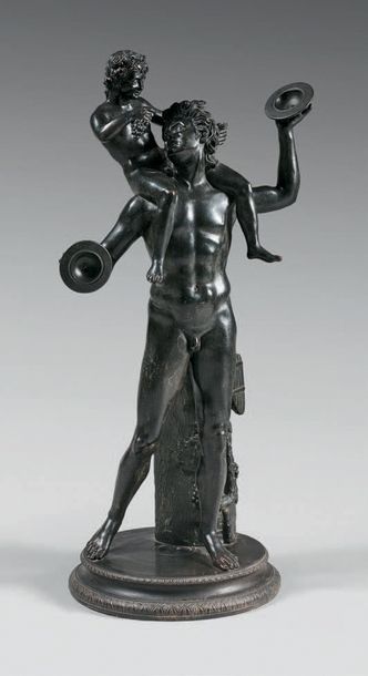 null Statue en bronze patiné représentant un faune aux cymbales portant Bacchus enfant....