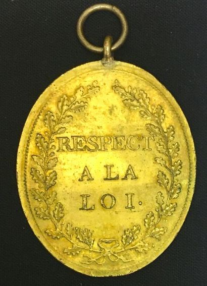 null Oval gilt bronze insignia of a Magistrate, stamped on both sides with the legend...