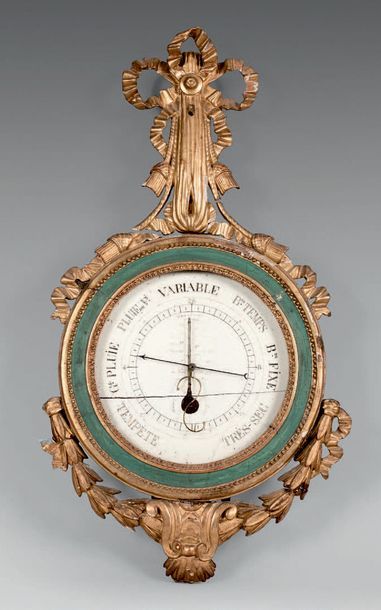 null Mercury barometer and alcohol thermometer in a circular frame with a gilded...