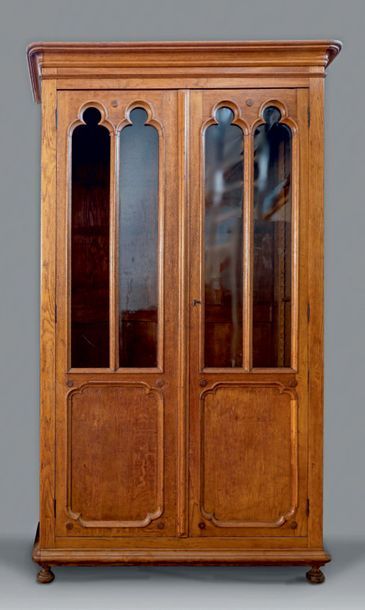 null Large oak bookcase opening with two glass doors with moulded decoration of neo-gothic...