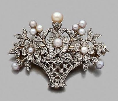null Brooch featuring a floral vase in 750-thousandths gold and 925-thousandths silver...