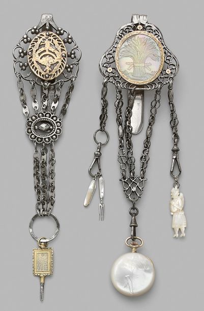 Set of two metal castelaines, one adorned...