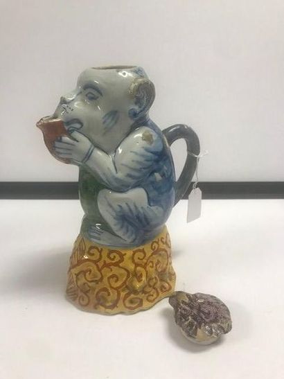 DELFT Covered jug in the shape of a monkey sitting on a base with a yellow base decorated...