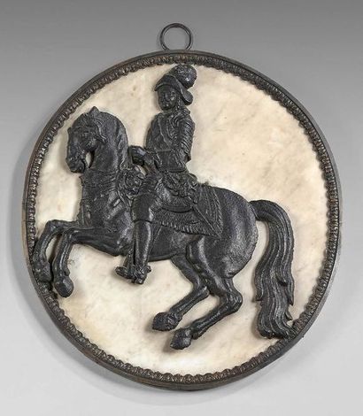 null Large medallion decorated with a cast iron rider on a veined white marble background...