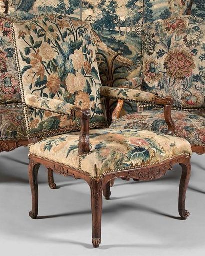 null Armchair with flat curved backrest upholstered in walnut carved with foliage,...