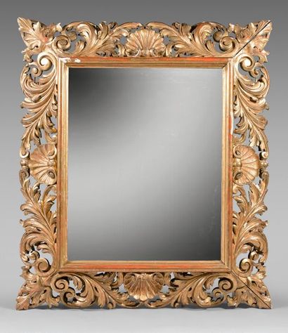 null Large bevelled mirror in a gilded wood frame with an upside-down profile carved...