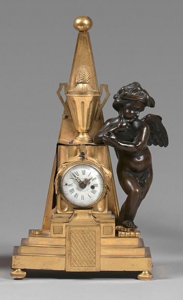 null Small gilt bronze clock decorated with a pyramid, an urn and a laurel wreath...