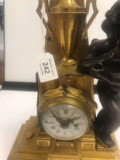 null Small gilt bronze clock decorated with a pyramid, an urn and a laurel wreath...