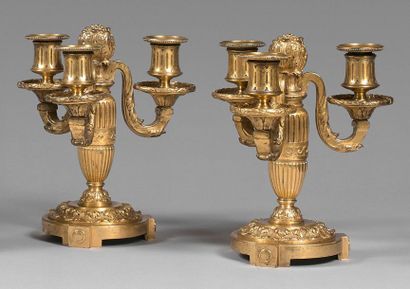 null Pair of low gilt bronze candelabra with three leafy lights. The baluster was...