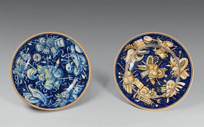 null Pair of round majolica dishes decorated with trophies of arms on a blue background...