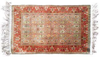 HEREKE Fine silk carpet decorated with boteh lines on an almond background. Floral...