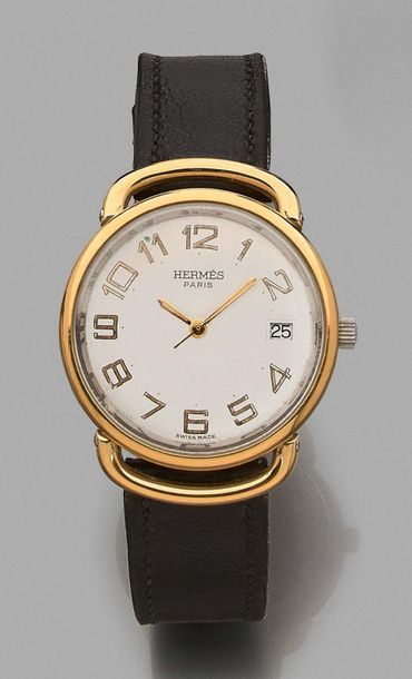 HERMES 
Wristwatch in steel and gold-plated metal.
Round case, back with snap closure....