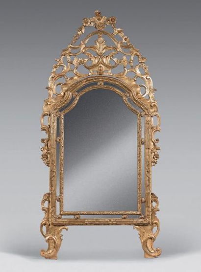 null Mirror in a double gilded wooden frame, with openwork pediment carved with flowers...
