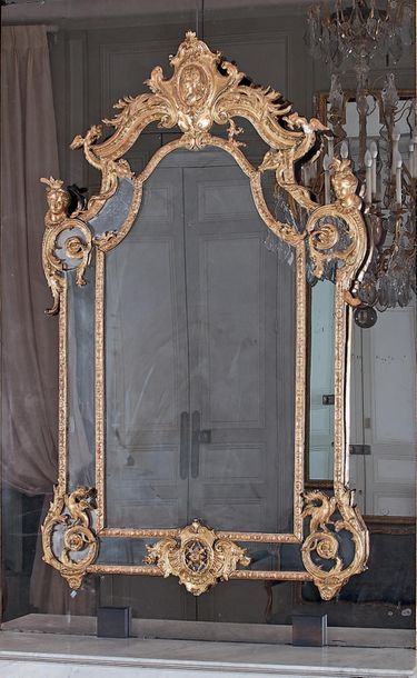 null Mirror in a double gilded wooden pediment frame carved with a medallion, dragon...