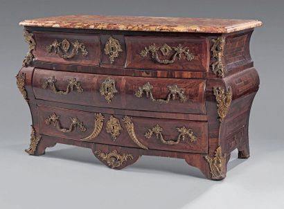 null Tomb-shaped chest of drawers in rosewood veneer with four drawers on three rows....