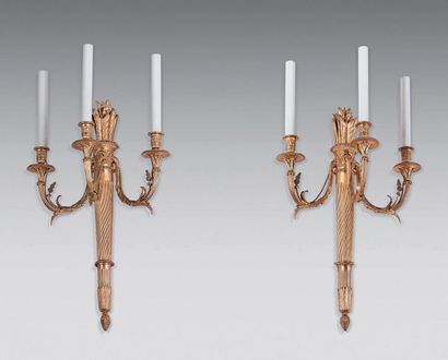 null Pair of gilt bronze three-light sconces with finials, the shaft in quiver.
Louis...