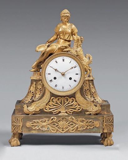 null Gilt bronze clock decorated with a female allegory of fidelity holding a mirror....