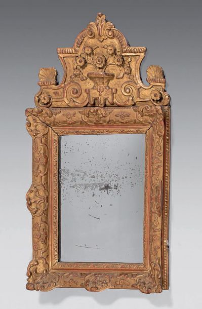 Mirror in a gilded wooden pediment frame...